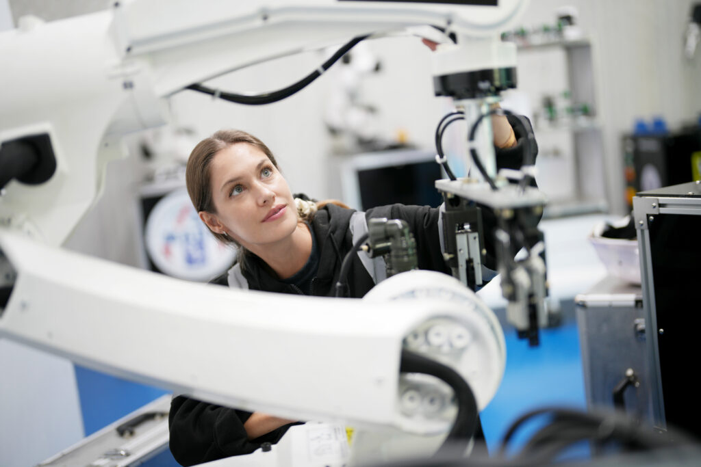 engineer inspecting automatic ai robot arm and machines in factory. engineer inspecting automatic ai